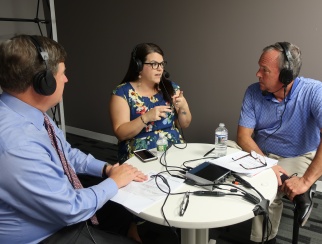 Nicole Panettieri (center) with co-hosts David French (left) and Bill Thorne (right).